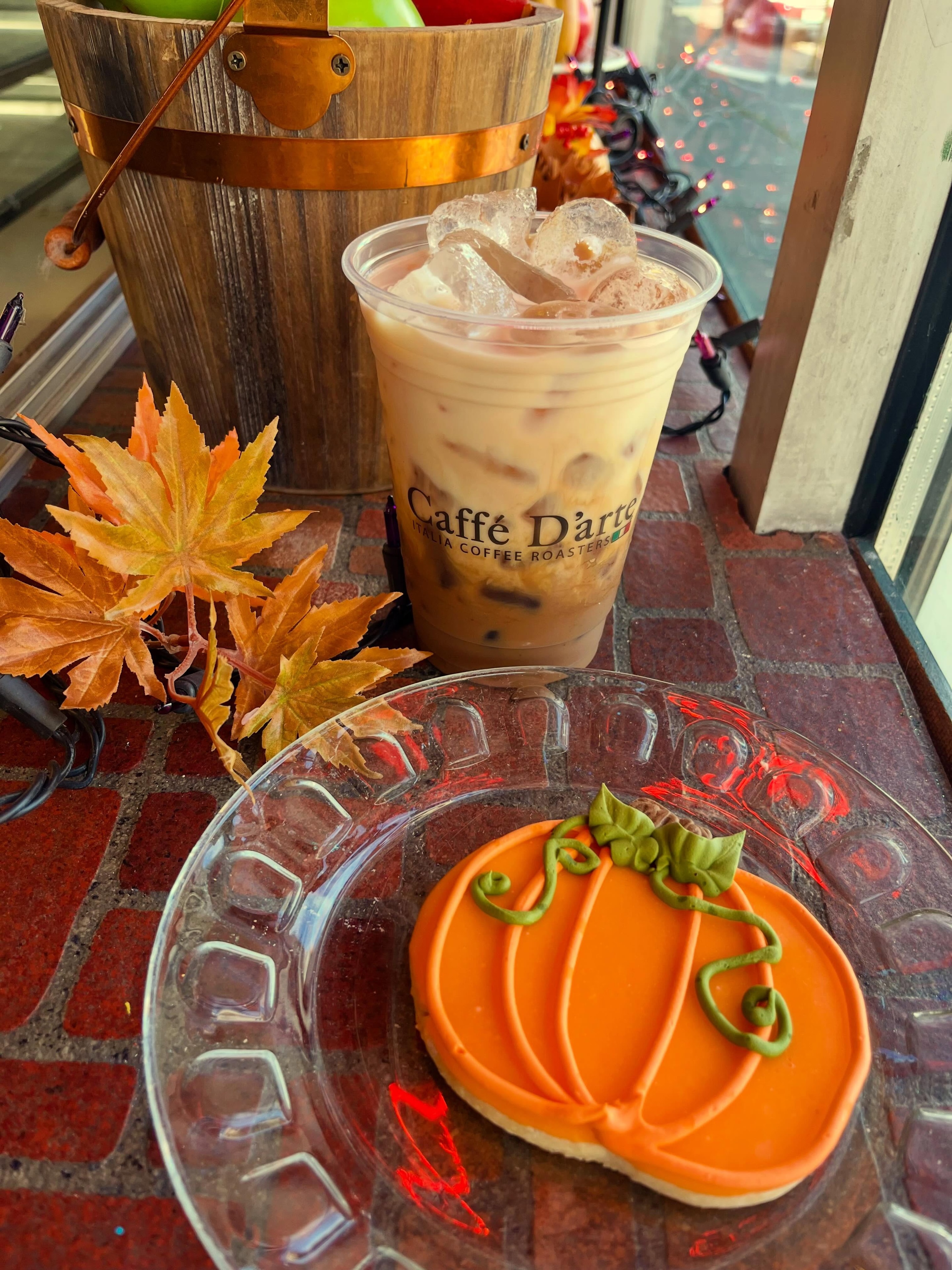 Autumn iced coffee with a pumpkin sugar cookie