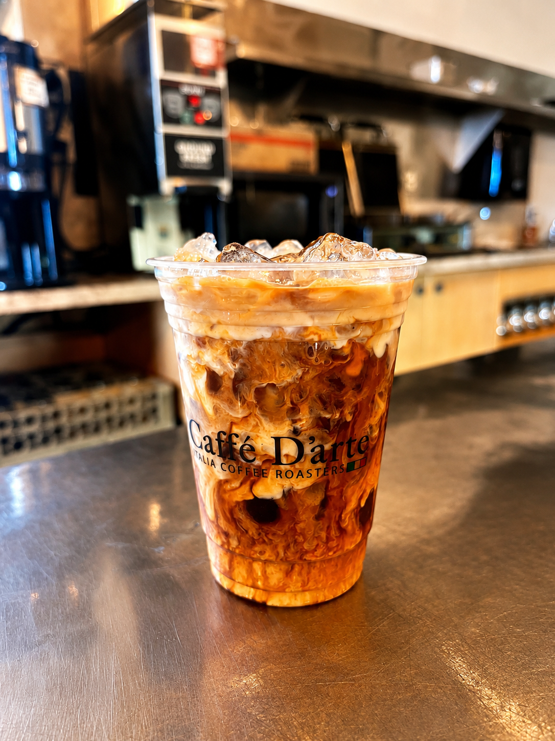 Iced Caffe D'arte latte on the bakery counter
