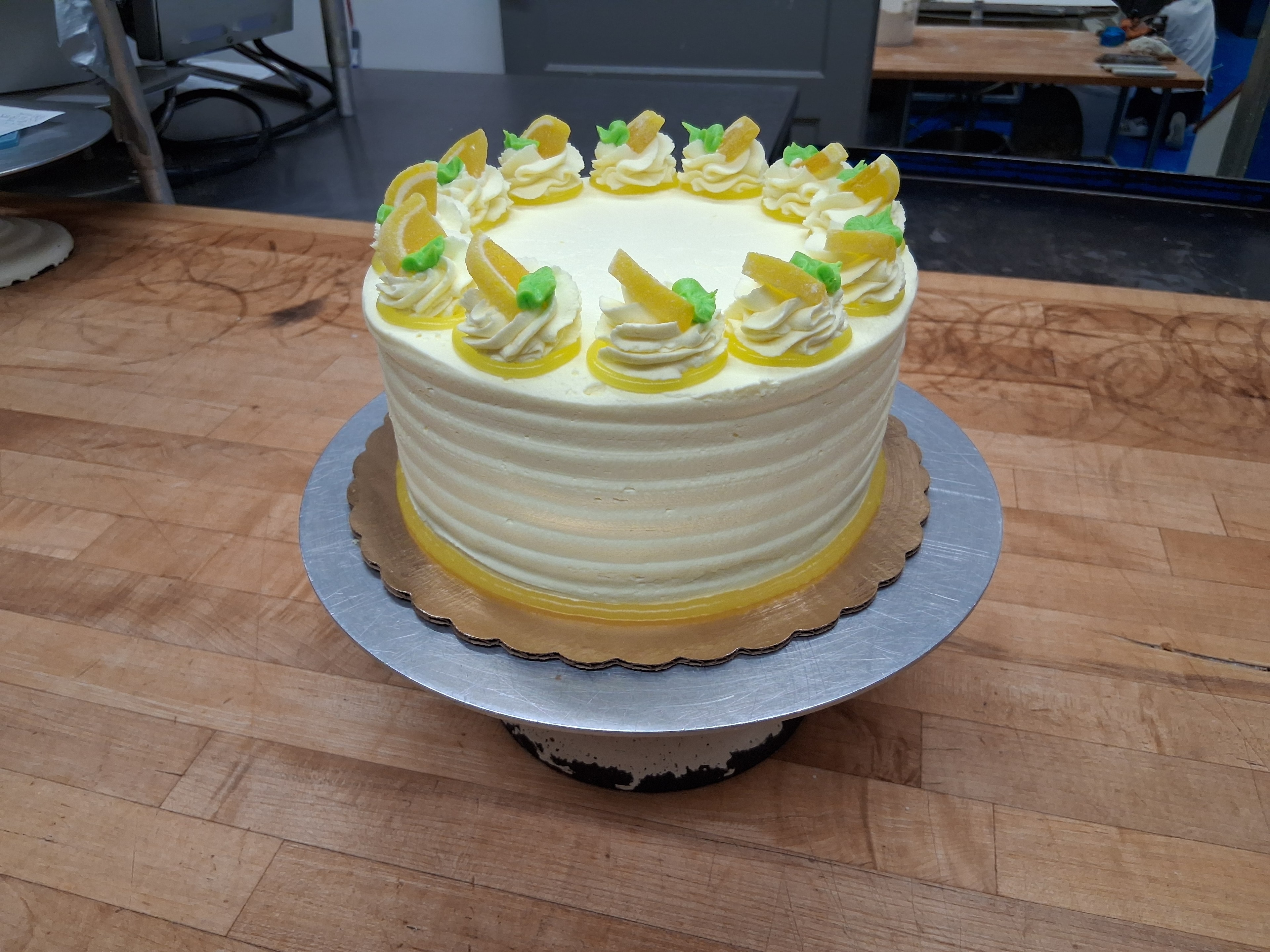 Lemon cake with cream frosting and candied lemon slice decorations